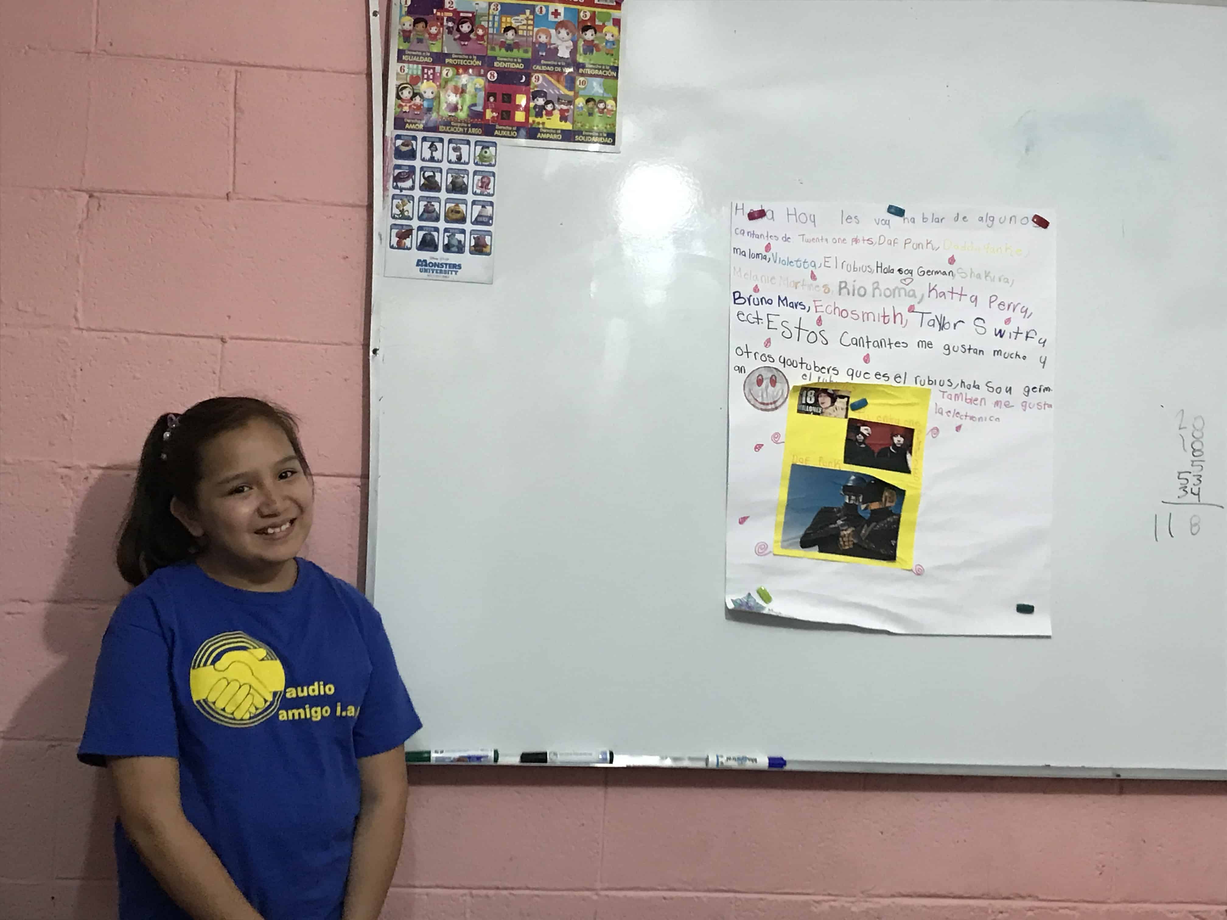 Niña sonriente con playera de Audio Amigo, beneficiaria de las terapias